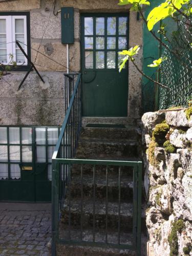 a green door on a house with stairs at Casa da Moita in Moita