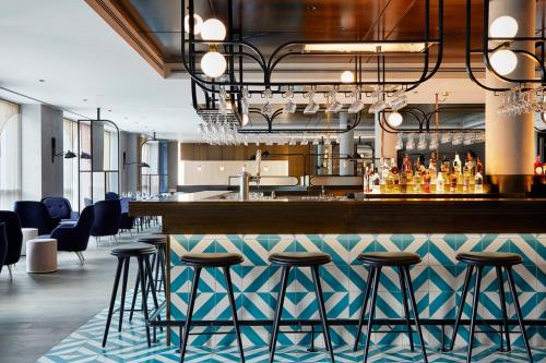 a bar in a restaurant with a blue and white tile at PURO Kraków Kazimierz in Kraków