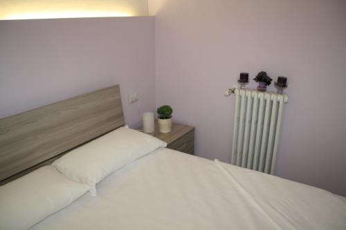 Кровать или кровати в номере LE COLONNE MILANO
