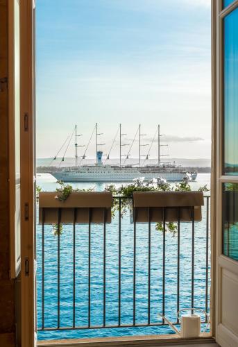 a view of a cruise ship from a window at Palazzo Alfeo Aparthotel in Siracusa