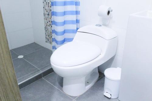 a bathroom with a white toilet and a shower at Casa Anita in Cartagena de Indias