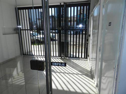 a glass door with a gate in a building at Confort Platense Centro Zona Catedral in La Plata