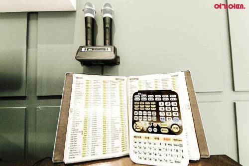 a book with a remote control sitting on top of it at Plum Hotel in Siheung