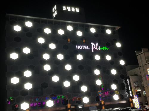 a building with a bunch of lights on it at Plum Hotel in Siheung