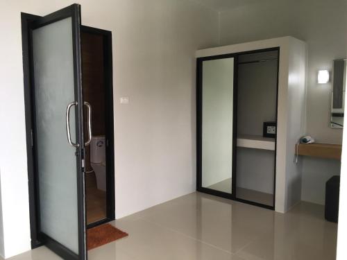 a bathroom with two mirrors on the wall at Baan Fran Sim Da in Bang Tao Beach