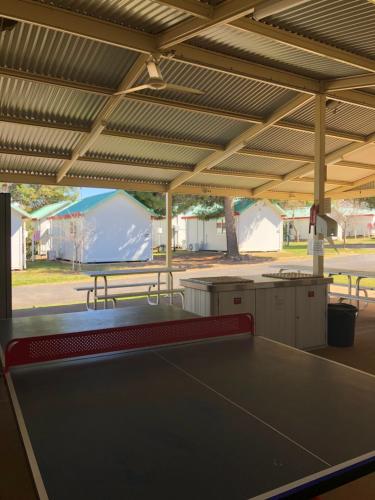 a ping pong table in a pavilion with a tent at Parkes Country Cabins in Parkes