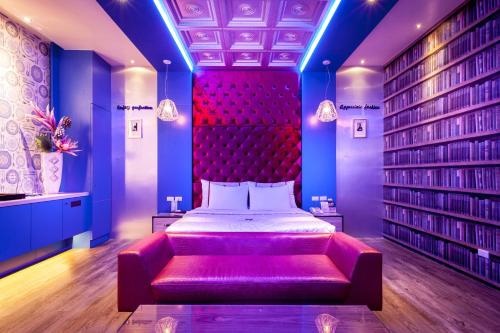 a bedroom with a bed and a red headboard at Ouwei Motel in Tainan