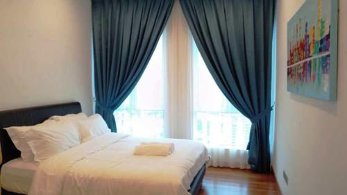 a bedroom with a bed with blue curtains and a window at Tamu Apartment Kuala Lumpur by Q Luxe in Kuala Lumpur