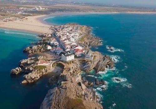 an aerial view of a small island in the ocean at The Wave House in Baleal