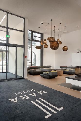 a lobby with a look at art written on the floor at MARA Hotel in Ilmenau