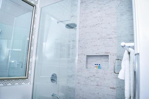 a bathroom with a shower with a glass door at JamGolia Place in Mandeville