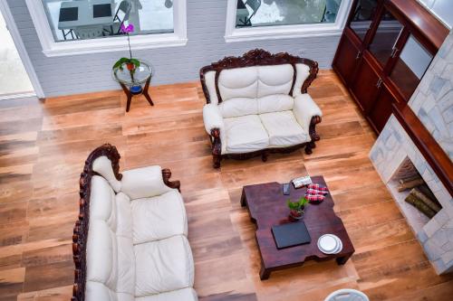 an overhead view of a living room with two chairs and a table at JamGolia Place in Mandeville
