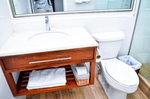 a bathroom with a sink and a toilet at JamGolia Place in Mandeville