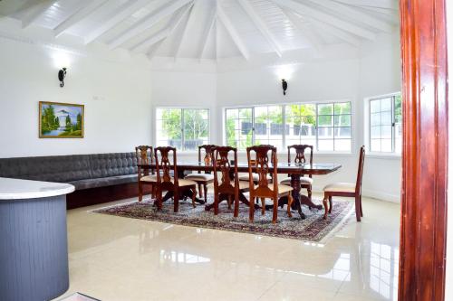 a dining room with a table and chairs at JamGolia Place in Mandeville