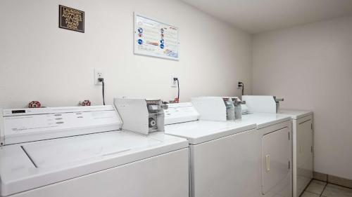 a white laundry room with white washing machines at Best Western Lakewood- Historic Landmark in Lakewood