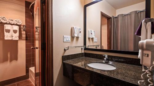 a bathroom with a sink and a mirror at Best Western Elko Inn in Elko