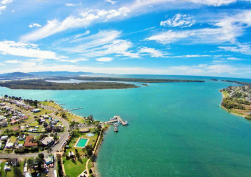 an aerial view of a river with houses and a harbor at South Coast Retreat in Greenwell Point