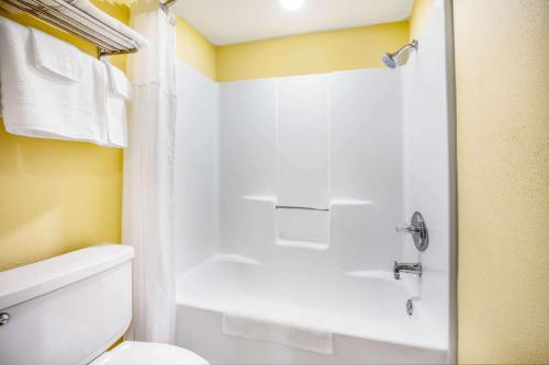 baño con ducha y aseo blanco en Days Inn by Wyndham Banning Casino/Outlet Mall, en Banning