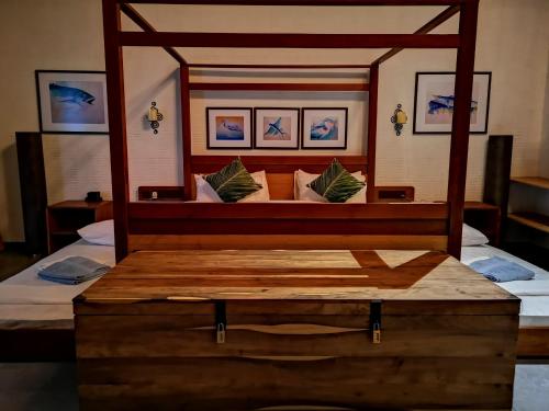 a bedroom with a bed with a wooden frame at Nolhi Escape in Nolhivaranfaru