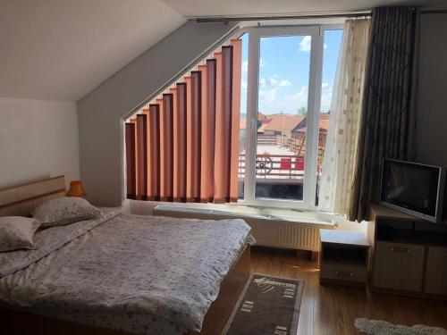 a bedroom with a bed and a large window at Casa Sterp in Jina
