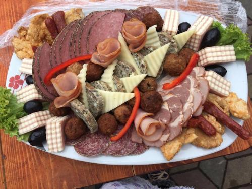 a plate of different types of food on a table at Casa Sterp in Jina