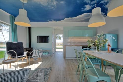 a living room with a blue ceiling at KOMFORTOWE DOMKI Brzozowa Przystań nad morzem we Władysławowie in Władysławowo