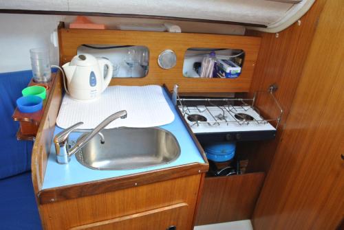 a kitchen with a sink and a stove at nuit sur un voilier in Nonsard