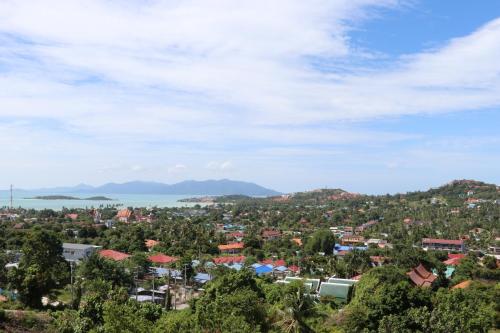 a view of a city and the ocean at Magic suites Seaview villas, Koh Samui in Choeng Mon Beach