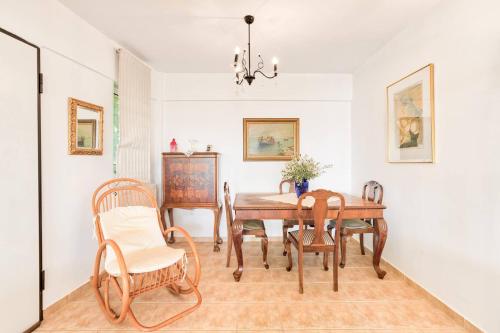 a dining room with a table and chairs at Kate's Beach Villa in Porto Rafti