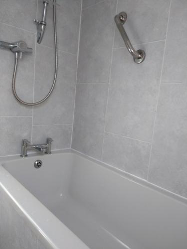 a bathroom with a bath tub and a shower at Very Central Location- Parking-4 Beds-2 Bedrooms in Belfast