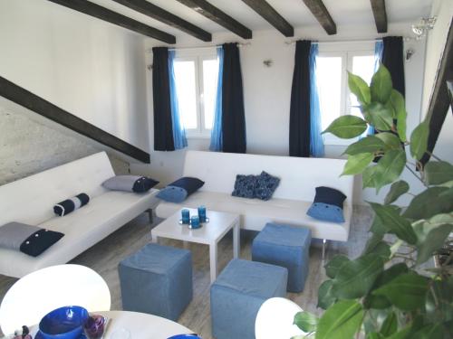 a living room with blue and white furniture and a plant at Split Inn Apartments in Split