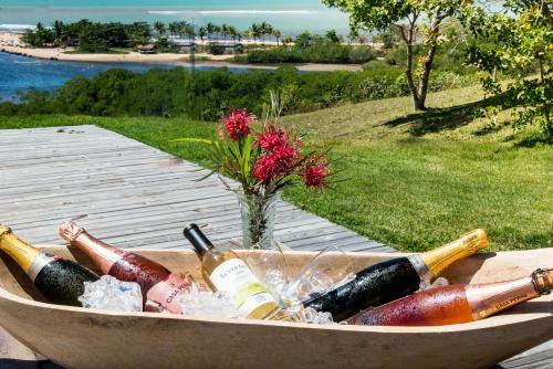 a basket filled with bottles of wine on a table at Caraiva Bela Vista in Caraíva