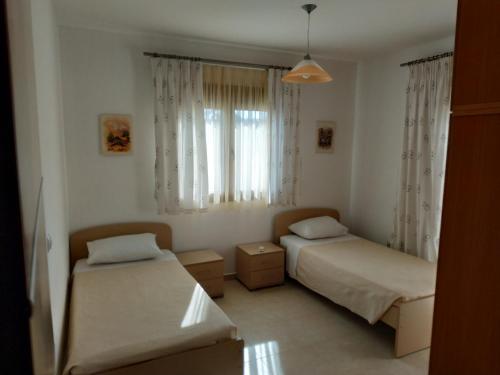 a bedroom with two beds and a window at Villa Miramonti in Afantou