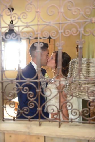 a bride and groom kissing in front of a gate at Relax B&B Lavendine Pure in Genk