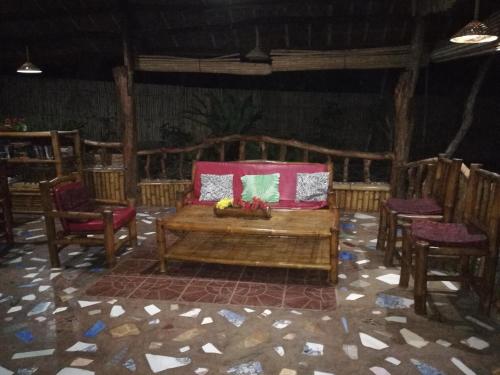 a room with a couch and chairs and a table at Bohol-Lahoy Dive Resort in Guindulman