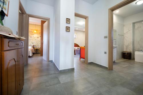 a room with a hallway with a bathroom with a tub at Iridanos Villa in Kissamos