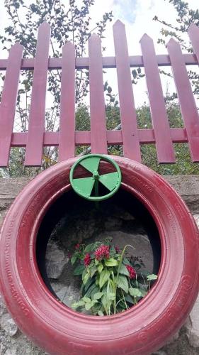 a red fence with a flower planter in front of it at 1957 To Rodo kai to Roido in Karpenision