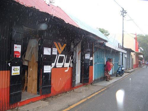 a person standing outside of a building on a street at L'Heritage - Vue sur mer in Rodrigues Island