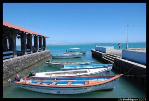 a group of boats tied up to a dock at L'Heritage - Vue sur mer in Rodrigues Island