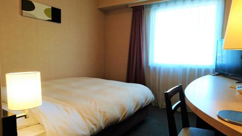 Ένα ή περισσότερα κρεβάτια σε δωμάτιο στο Hotel Crown Hills Kushiro