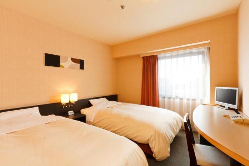 Кровать или кровати в номере Hotel Crown Hills Kushiro