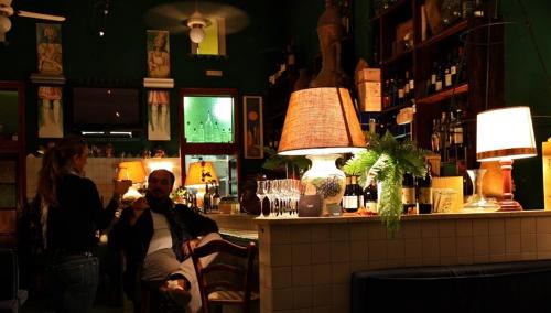 a man and a woman sitting at a bar at Locanda del Bagatto in Milazzo