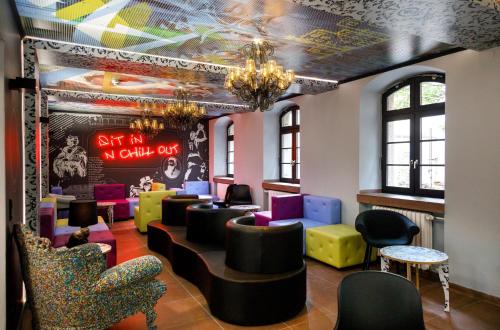 a waiting room with colorful chairs and tables at Youth Hostel Würzburg in Würzburg