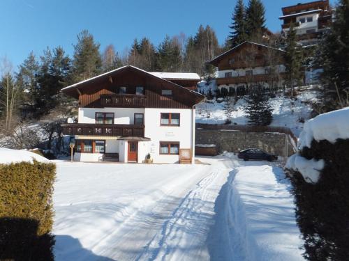 a house in the snow with a driveway at Haus Gantioler in Mieders