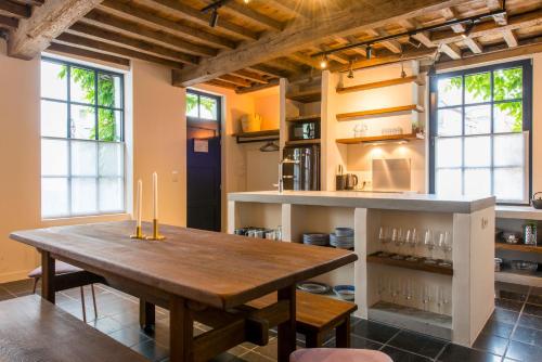 a kitchen with a wooden table in a room at Friday Gent in Ghent