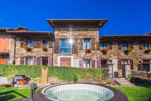 a building with a pool in front of it at B&B Il Folletto del Lago in Stresa