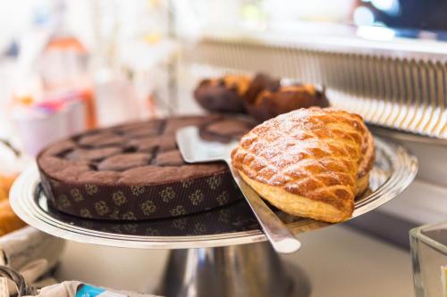 a plate with a chocolate pie and bread on a table at B&B Il Folletto del Lago in Stresa