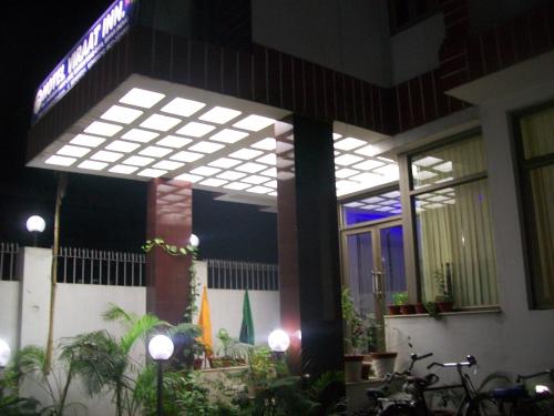 a house with a large window with lights on it at Hotel Viraat Inn in Gaya