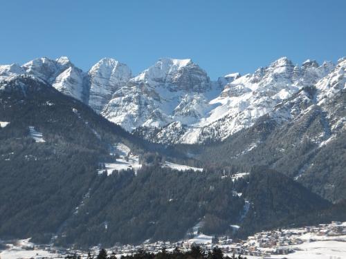 a snow covered mountain range with a town in front at Haus Gantioler in Mieders