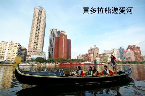 a group of people in a boat in the water at 麗馨商旅七賢館 in Kaohsiung